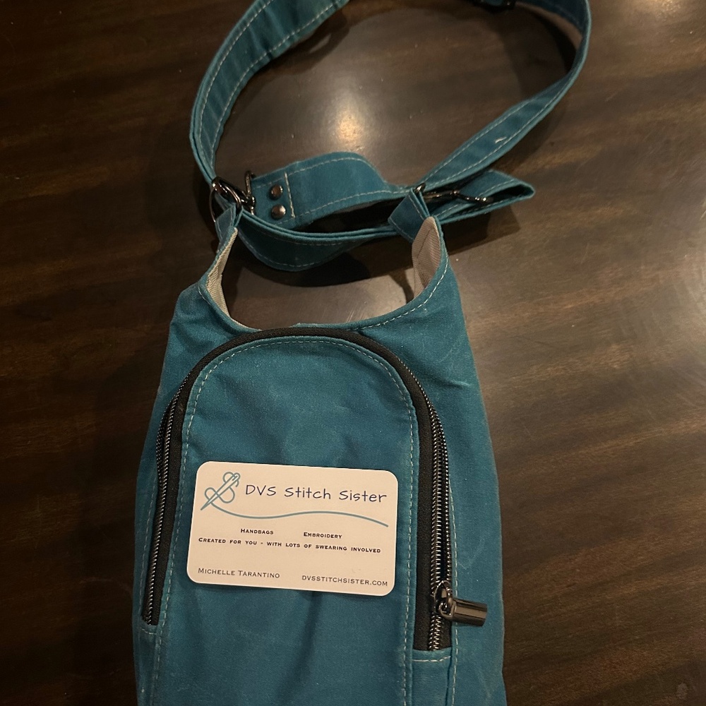 Shoulder bag that holds water bottle